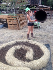 Natasha, just finished mixing soil and filling in the last bucket into the spiraled straw waddle.